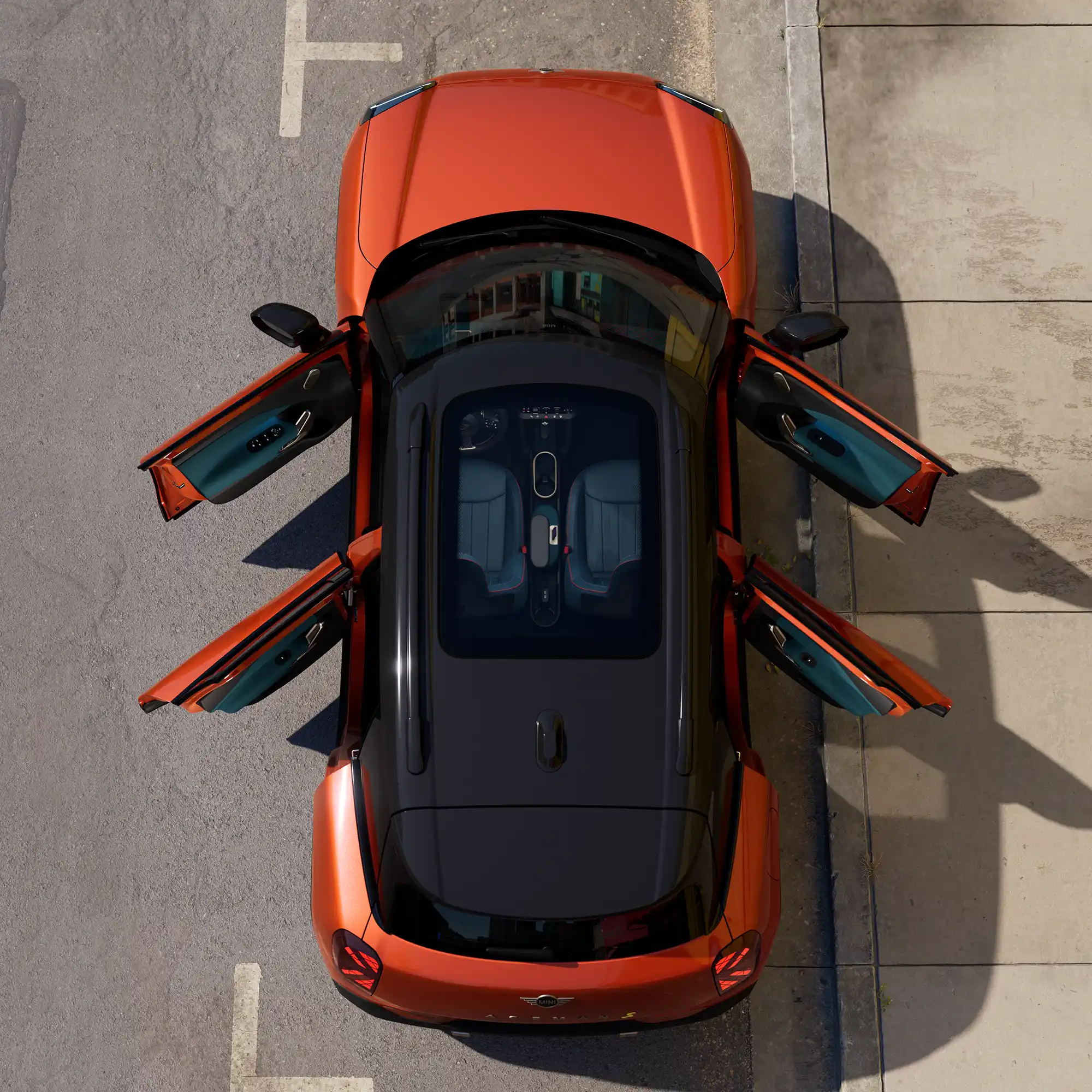 Top view of parked all-electric MINI Aceman in orange with open doors and sunroof