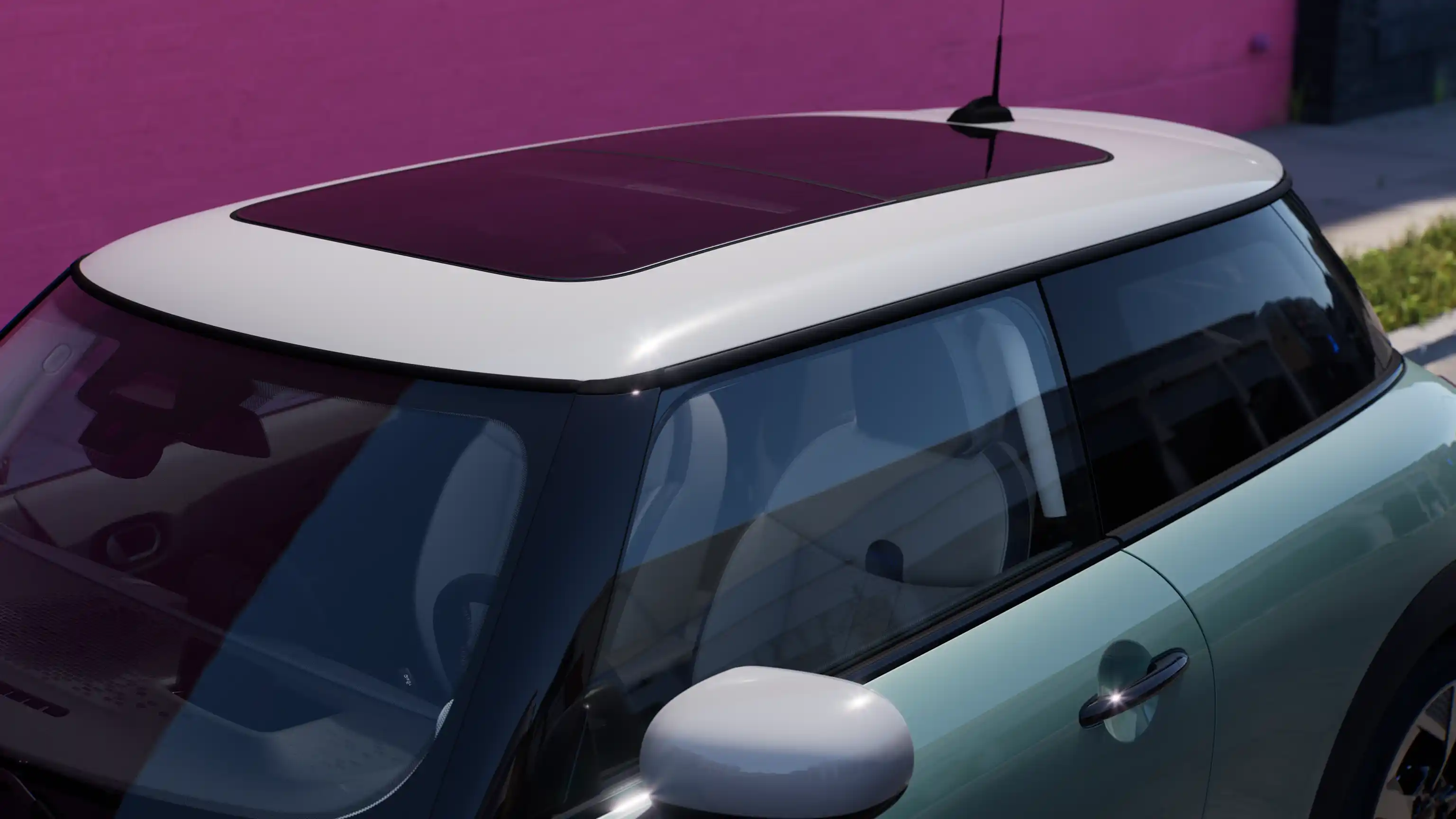 Top view of the MINI Cooper in Ocean Wave Green with contrast roof and big glass roof.