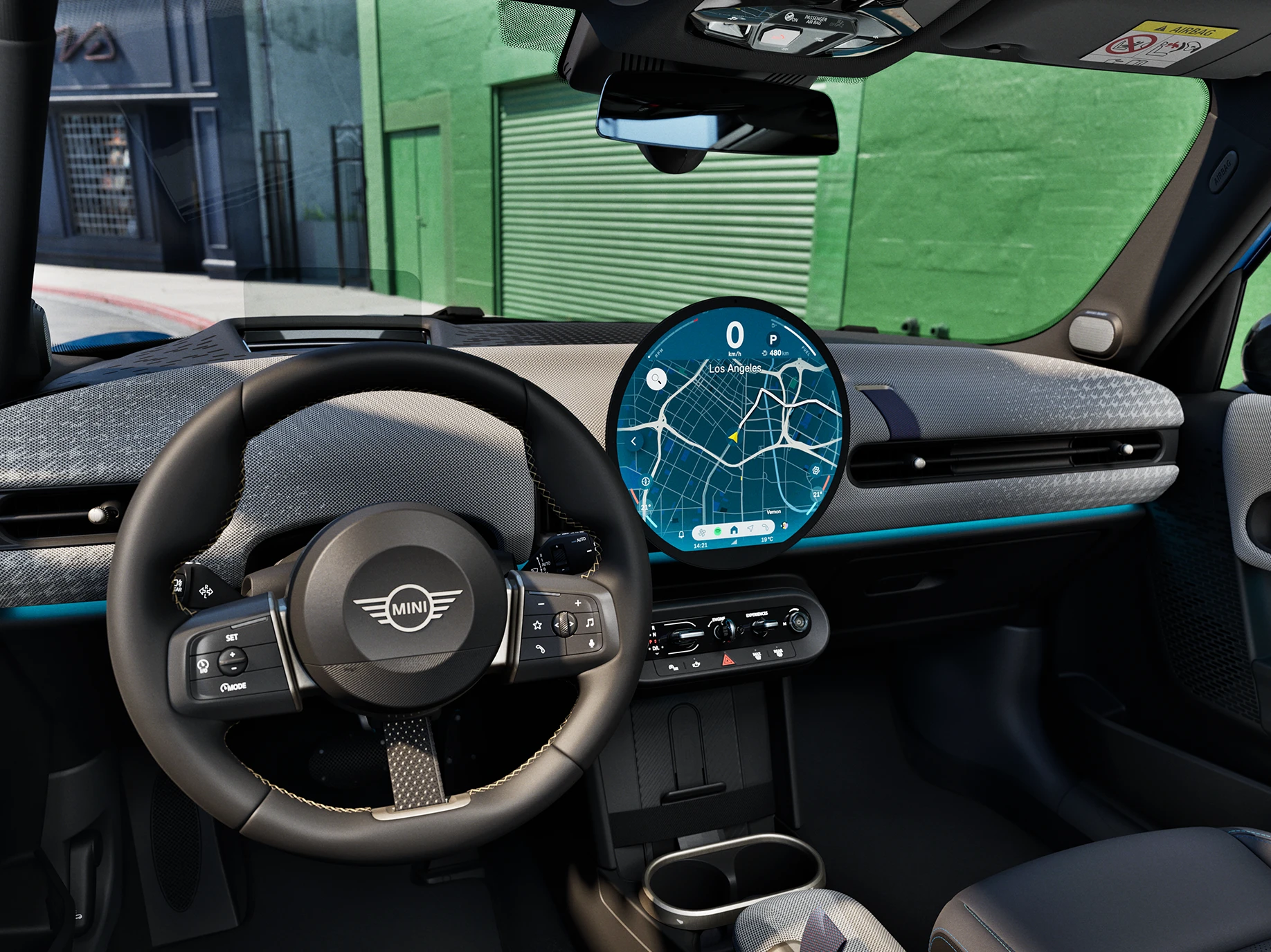 Interior view of the MINI Cooper 5-Door focusing on the steering wheel, the dashboard and the interaction unit.