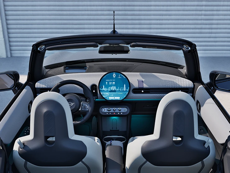 Rear view of the MINI Cooper Convertible interior with focus on the dashboard and the interaction unit.