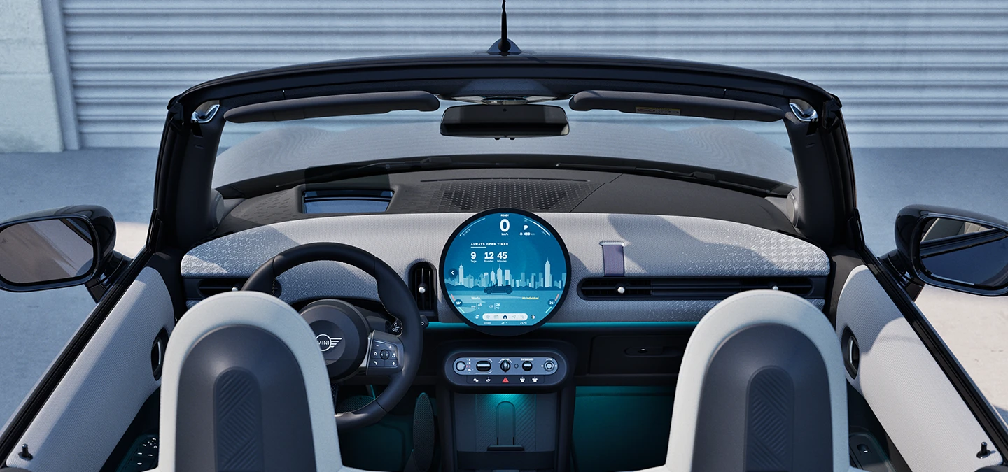 Rear view of the MINI Cooper Convertible interior with focus on the dashboard and the interaction unit.