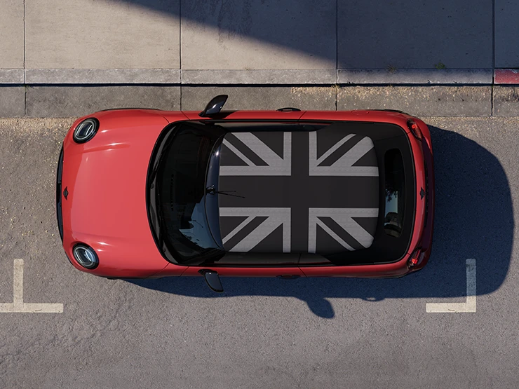 Top view of the MINI Cooper Convertible in Chili Red and MINI Yours Roof on a street.