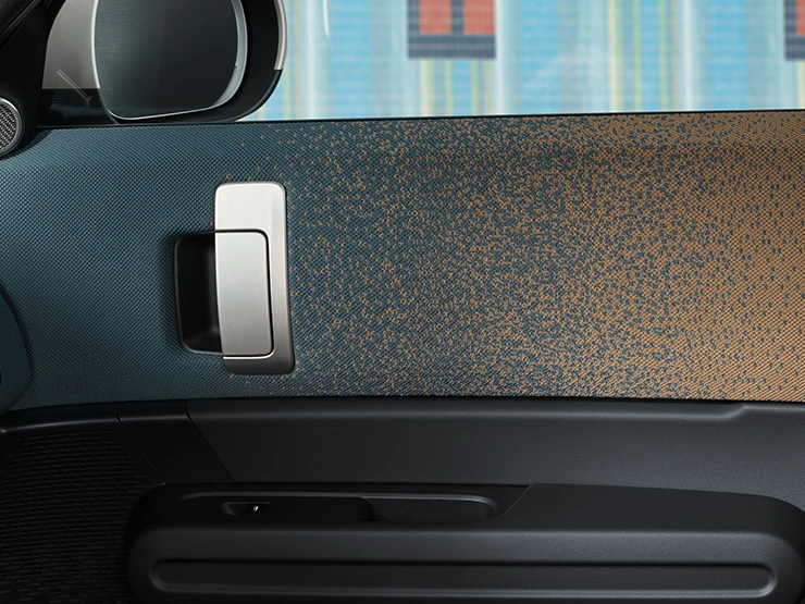 Close view of the interior design of the all-electric MINI Countryman focusing on the door and dashboard.