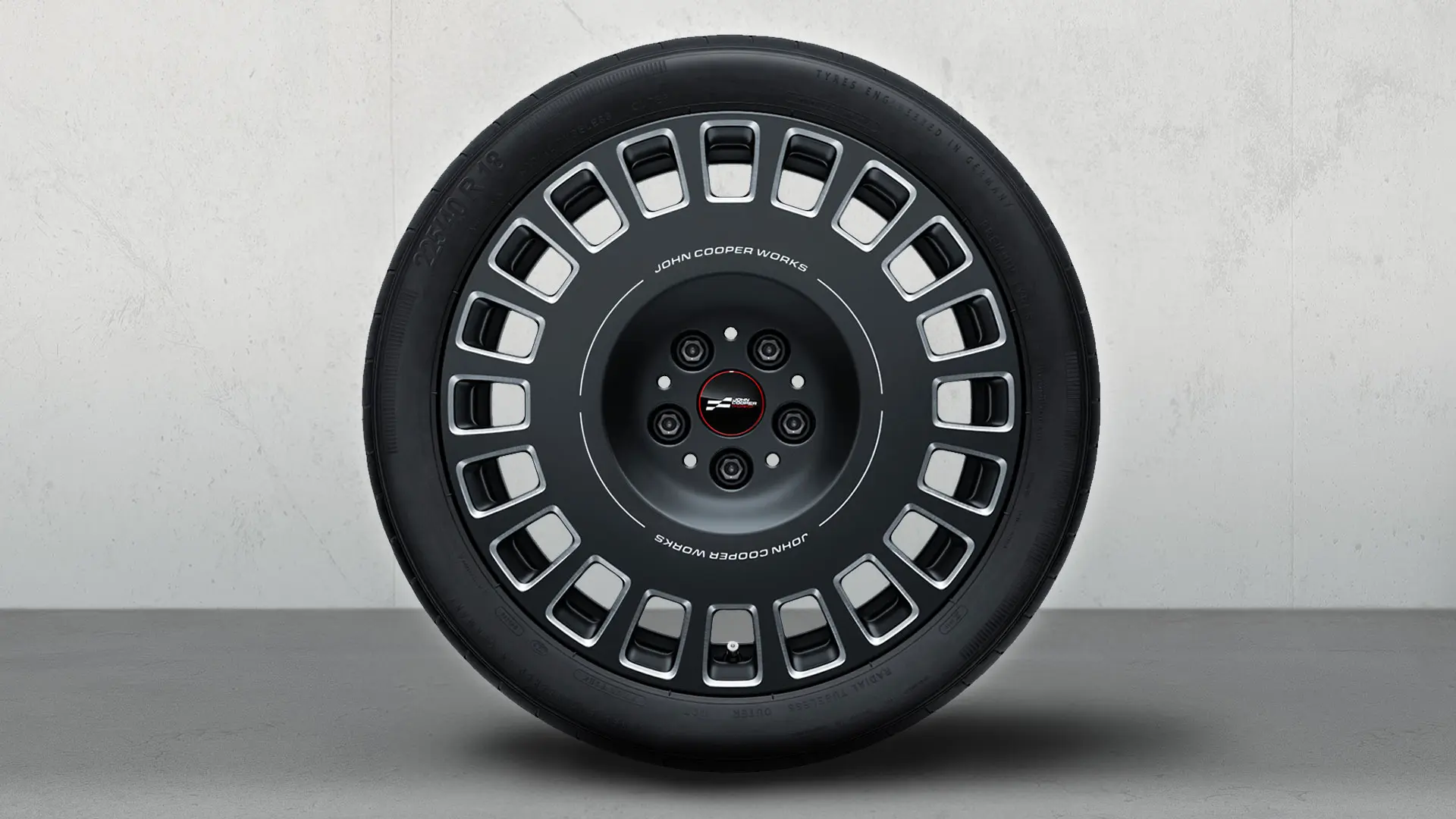 18'' JCW Rallye Spoke 992 wheel, featuring the JCW logo and two-tone design in Frozen Midnight Grey and gloss milled finish.