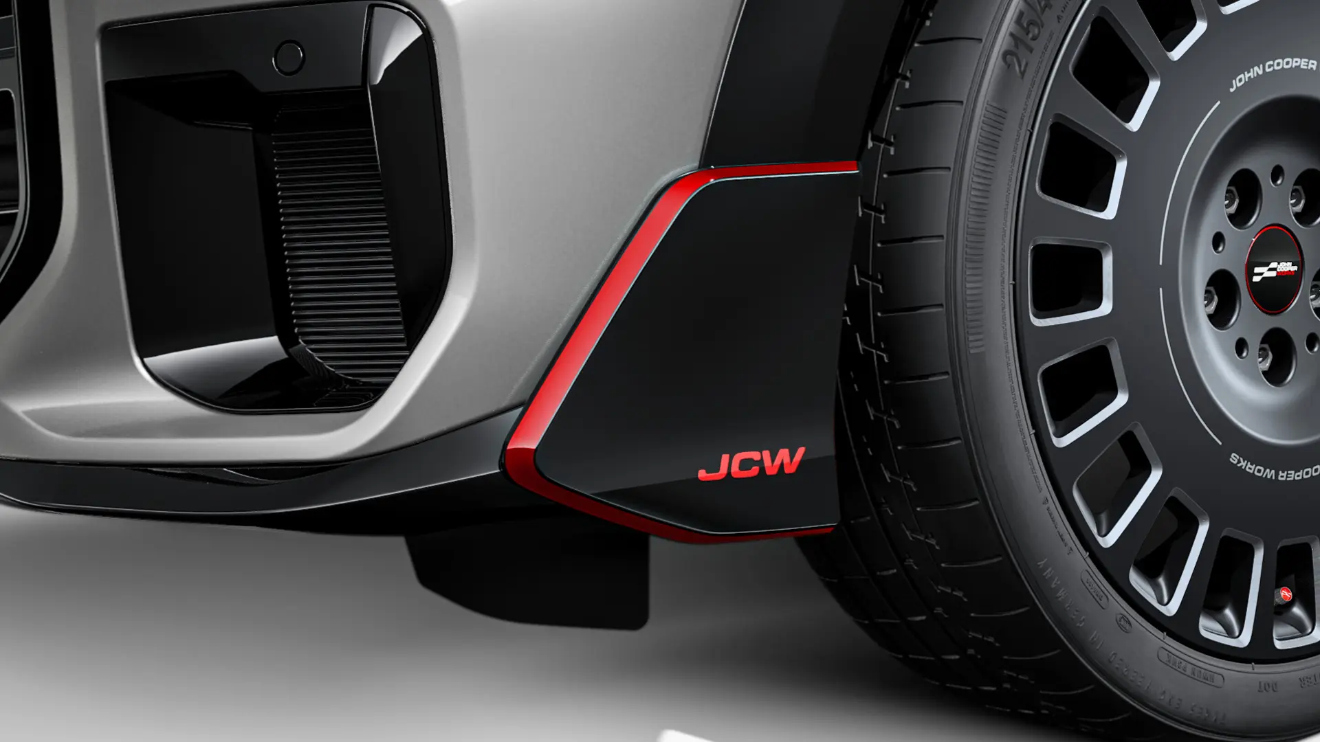 MINI John Cooper Works front winglet in black high gloss with red JCW lettering and accent stripes.