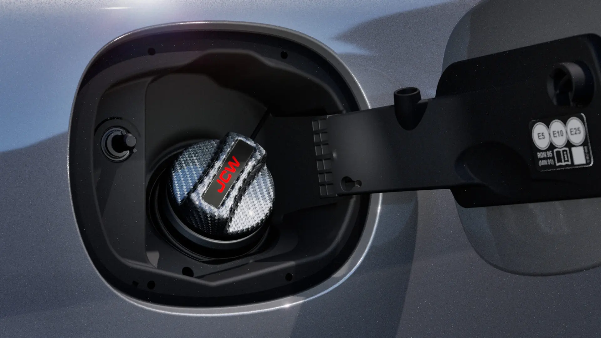 MINI John Cooper Works carbon fibre fuel tank cap with JCW inscription.