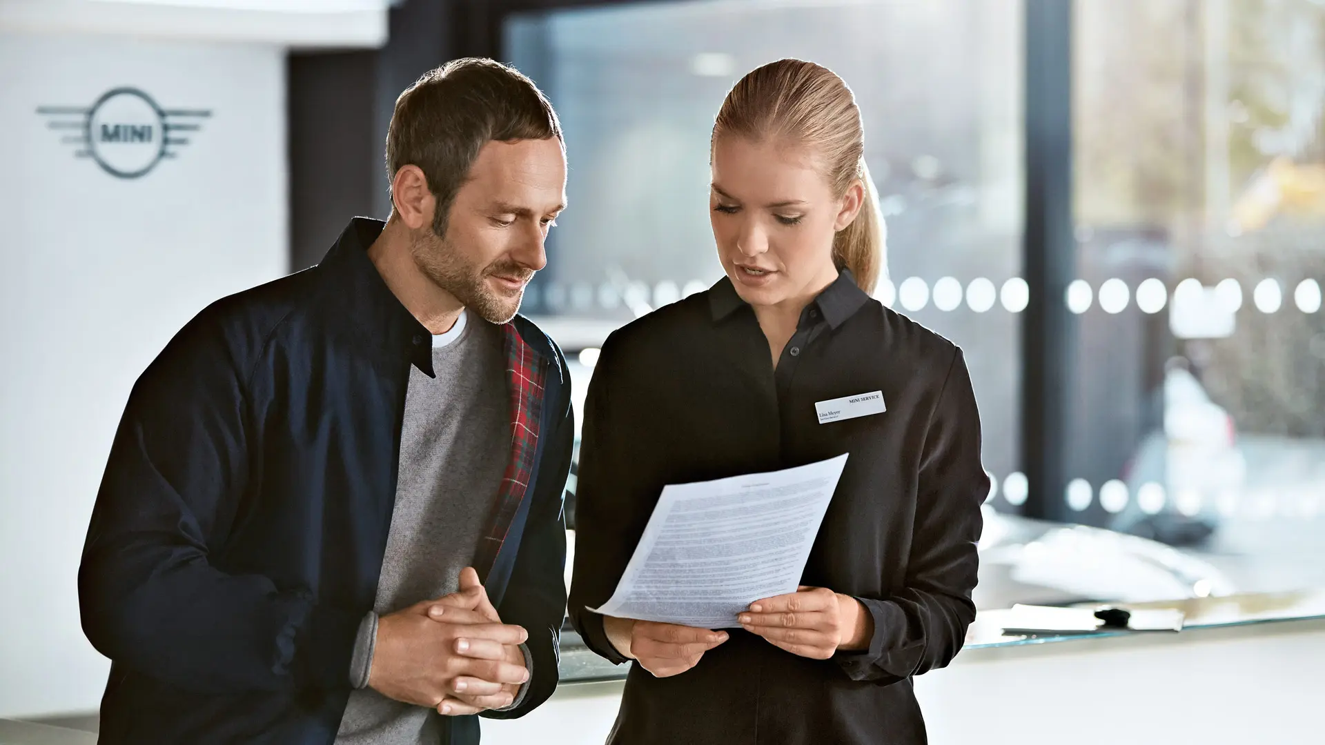 MINI Service consultant advising a customer about service plans at MINI Centre.