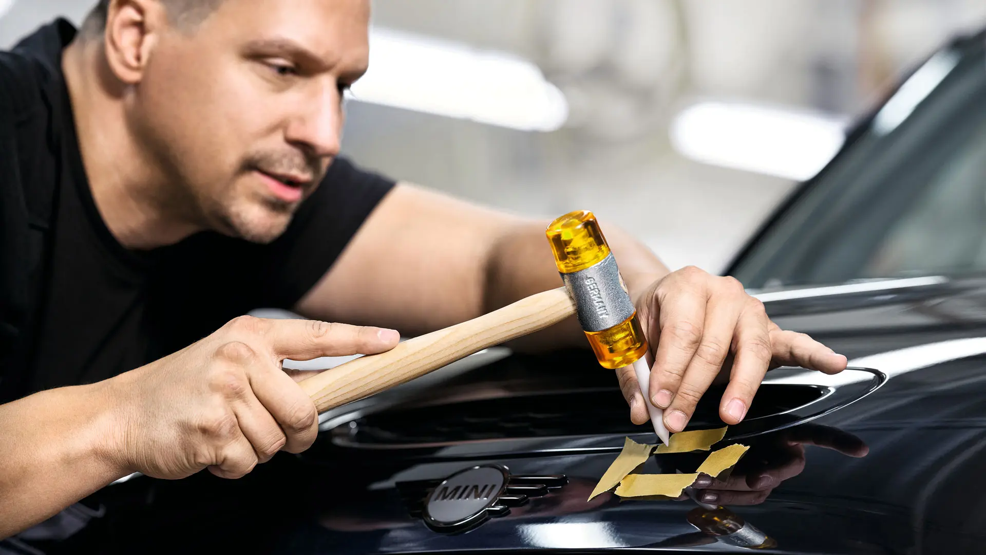 MINI employee repairs damage.