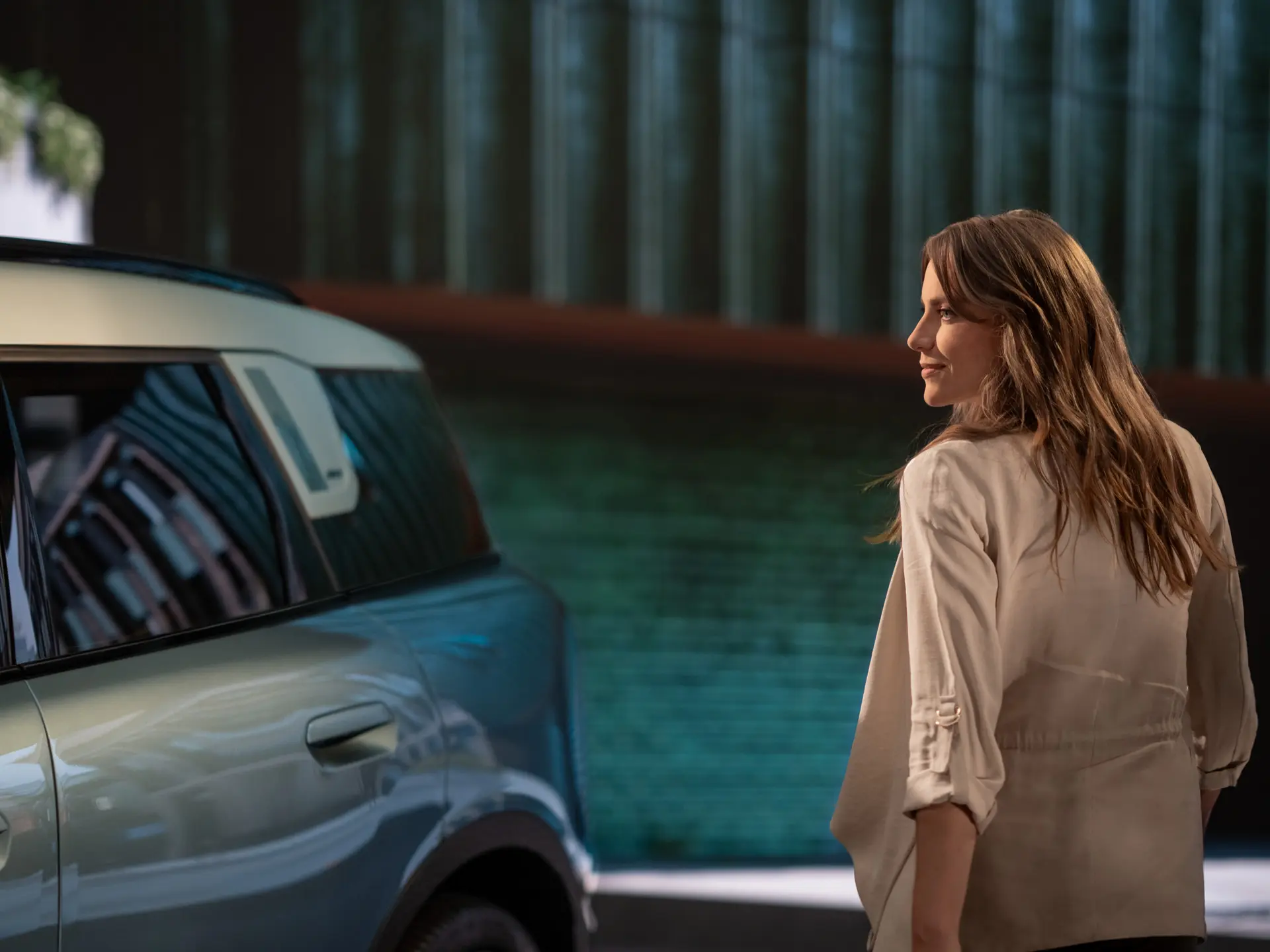 A woman standing next to a MINI