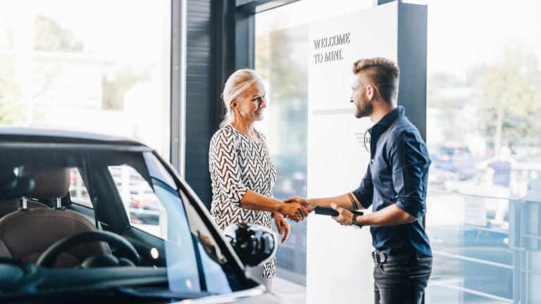 Two people shaking hands at MINI Retailer