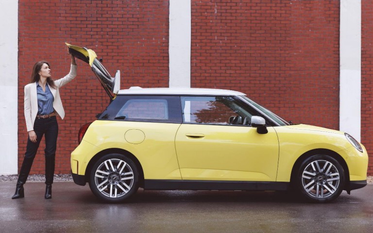 MINI Countryman with a man and woman standing behind on phones