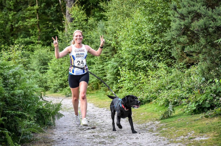 Woman with dog on the running path
