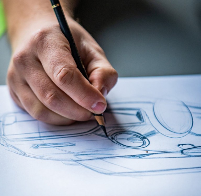 Detailshot of MINI Automotive Designer Josef Kuhlmann’s hand drawing the details of the headlights.