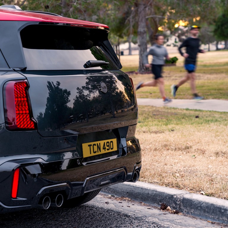Joggers running past a parked MINI Countryman