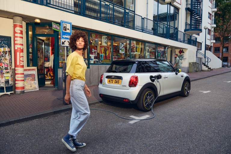 MINI electric car being charged at the side of the road