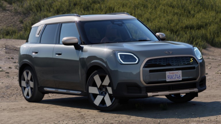 Women getting into Plug-in Hybrid on cliff top