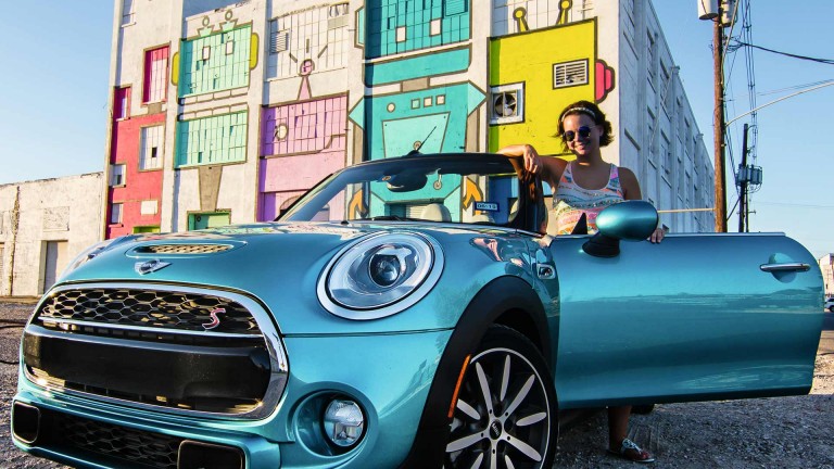 Woman posing with MINI Convertible Seaside Edition