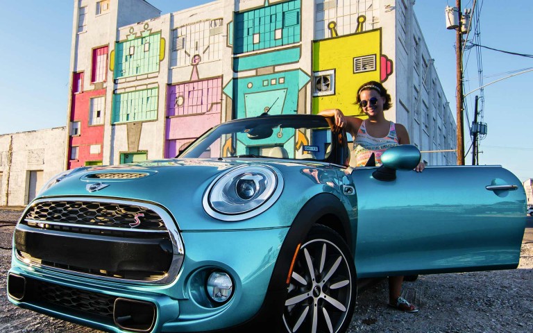 Woman posing with MINI Convertible Seaside Edition